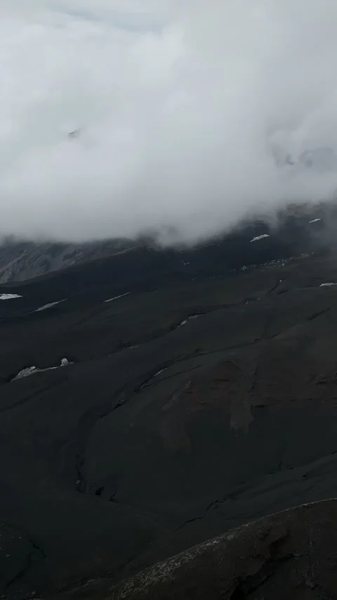 Tolbachinsky Dol ash valley and volcanic slopes under low clouds in Kamchatka Stock Footage 346557858