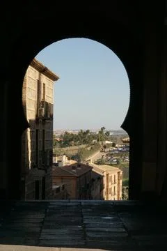 Toledo’s ancient View Framed by a moorish archway Stock Photos
