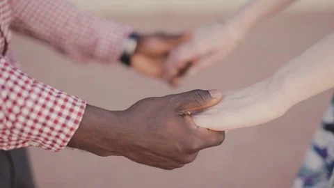 Tolerance theme . interracial couple holding hands Stock Footage 84089199