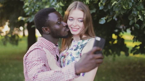 Tolerance theme. interracial couple take selfie. Stock Footage 86361202