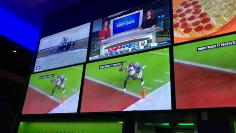 Tom Brady Throws Touchdown in His Last Game as Seen on Tv's in Sports Bar Stock Footage 230476567