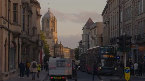 Tom Tower looms over Cornmarket Street &amp; the rest of Oxford England - Evening Stock Footage 230354663