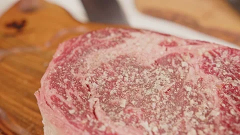 Tomahawk beef cut raw meat on a wooden board Stock Footage 201110224