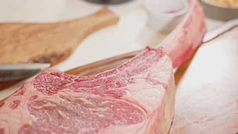 Tomahawk beef cut on a wooden board Stock Footage 201110237