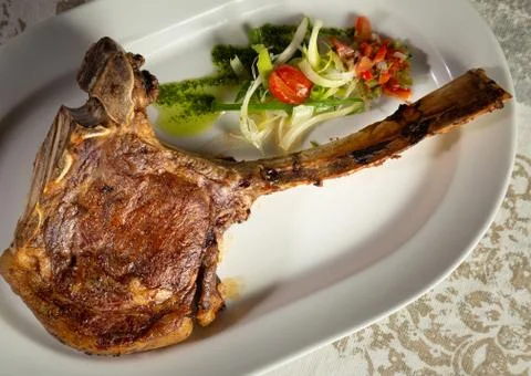 Tomahawk cut plate. Selective focus. Stock Photos