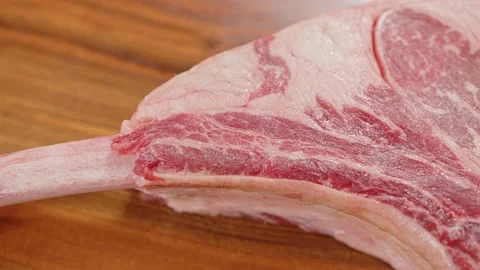 Tomahawk raw beef cut pan shot Stock Footage 201110227