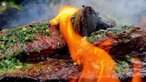 Tomahawk ribeye steak grilled directly on a hot stone Видео 336590694