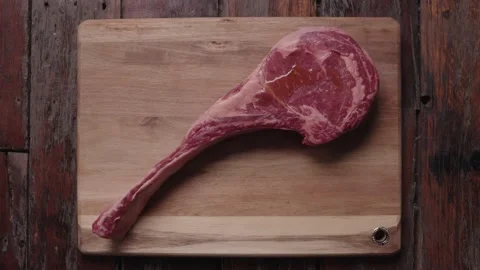 Tomahawk steak being oiled Stock Footage 194757237