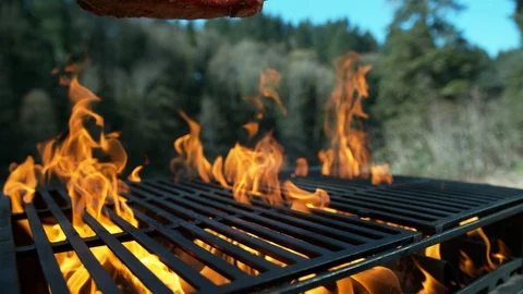 Tomahawk steak falling onto grill in slow motion.  Shot with Phantom Flex 4K Stock Footage 130351537