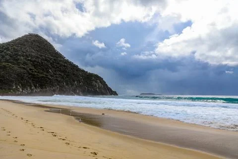 Tomaree Mountain rises dramatically above Shoal Bay Stock Photos