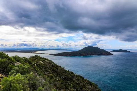 Tomaree Mountain rises dramatically above Shoal Bay Stock Photos