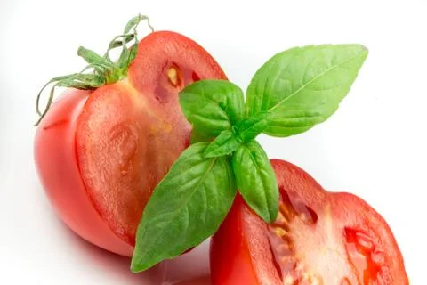 Tomato and basil leaf isolated Stock Photos