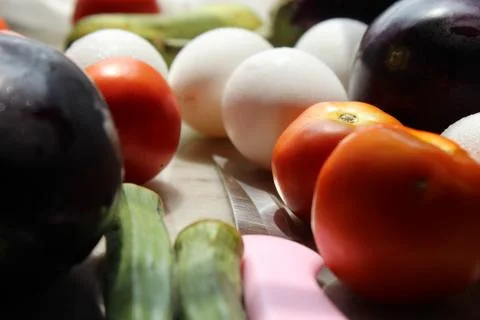 Tomato and eggs display with selective focus and fresh various raw organic veget Stock Photos