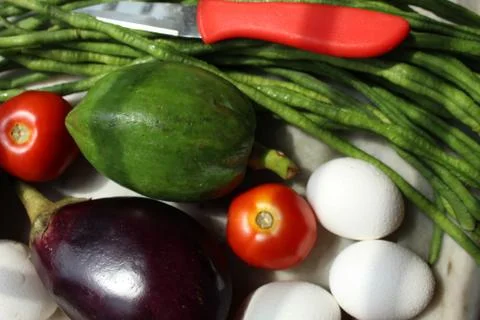 Tomato and eggs display with selective focus and fresh various raw organic veget Stock Photos