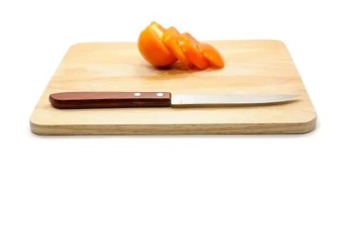 Tomato and knife on cutting board isolated on a white background Stock Photos