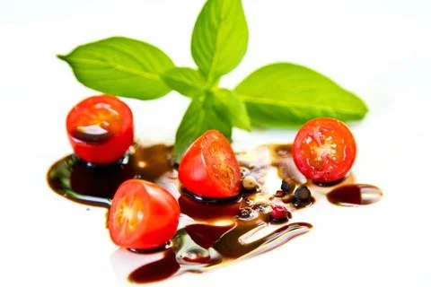 Tomato with basil and balsamic dressing Stock Photos