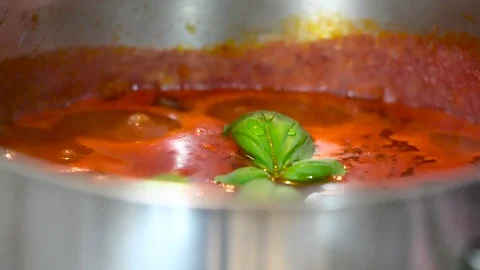 Tomato with basil in a pot cooking Stock Footage 74872480
