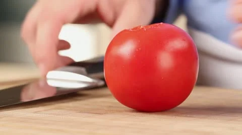 A tomato being chopped (close-up) Stock Footage 24672807