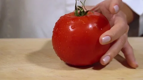 Tomato being cut on chopping board Stock Footage 79473275