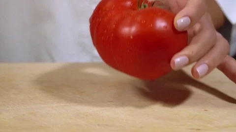 Tomato being cut on chopping board Stock Footage 79473280