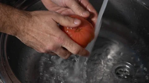 Tomato being washed Stock Footage 122822966