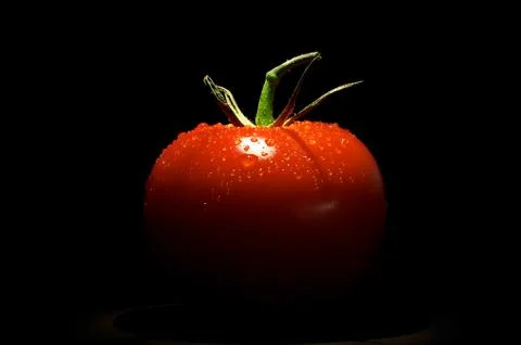 Tomato on black background Stock Photos