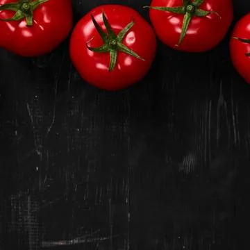 Tomato on a black background with realistic reflection and water drops. Fresh Stock Photos
