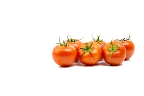 Tomato closeup on white background. Selective focus Stock Photos
