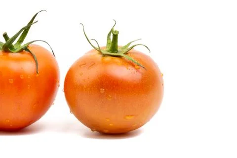 Tomato closeup on white background. Selective focus Stock Photos