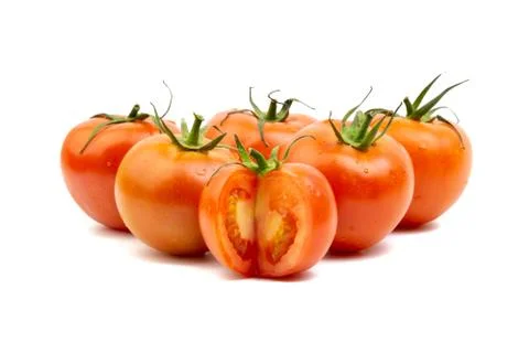 Tomato closeup on white background. Selective focus Stock Photos