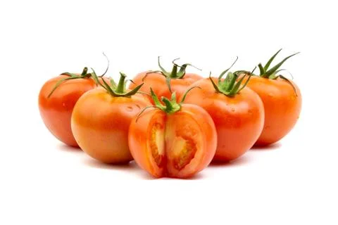 Tomato closeup on white background. Selective focus Stock Photos