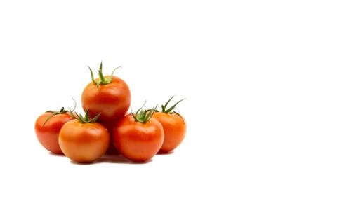 Tomato closeup on white background. Selective focus Stock Photos