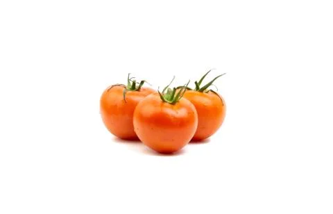 Tomato closeup on white background. Selective focus Фото
