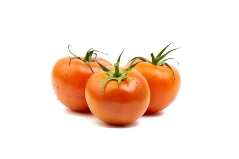 Tomato closeup on white background. Selective focus Stock Photos