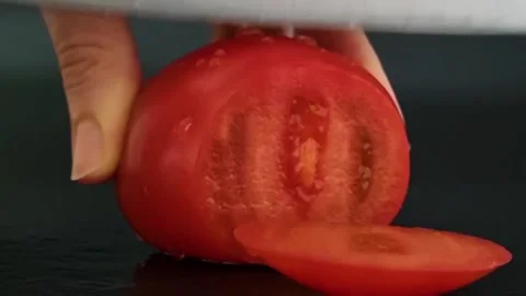 The tomato is cut into circles. Sliced ​​tomato. Video stock 220105835