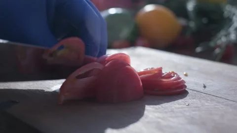 Tomato cut by the knife on the cooking board Stock Footage 204878477