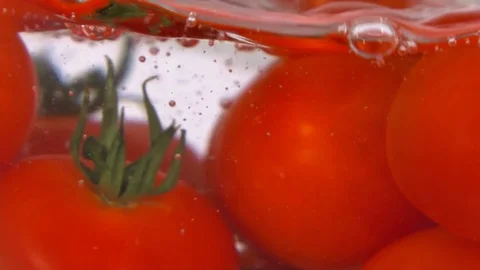 Tomato fall into the water close up Stock Footage 83008048