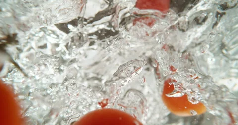 Tomato falling into hot water Stock Footage 311827768