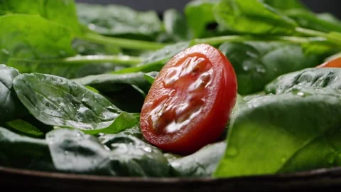 Tomato falling into salad Stock Footage 130876564