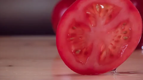 Tomato Falling in Super Slow Motion (1000fps) - Mesmerizing Fruit Impact Watch a Stock Footage 253298606