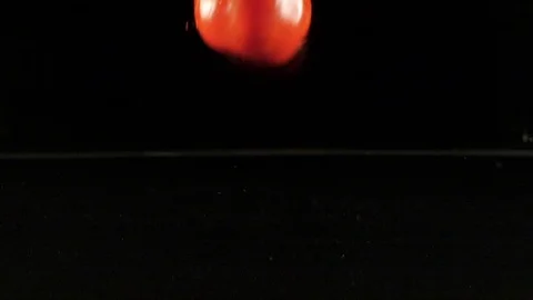 Tomato falling into water in slow motion Stock Footage 88809087