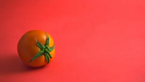 Tomato flat lay on pink background. Stock Photos