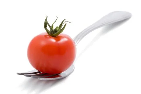 Tomato on fork isolated Stock Photos