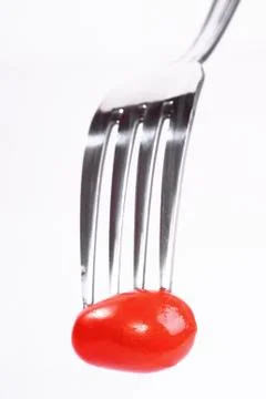 Tomato on fork Stock Photos