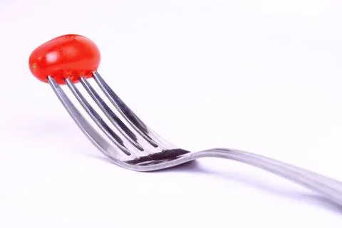 Tomato on fork Stock Photos