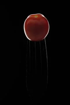 Tomato on a fork Stock Photos