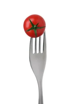Tomato on a fork on white Stock Photos