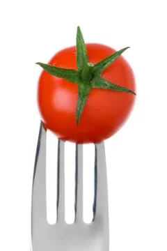 Tomato on a fork on white Stock Photos