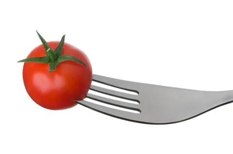 Tomato on a fork on white Stock Photos