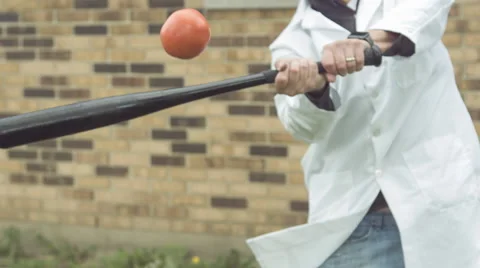 Tomato hit by baseball bat in slow motion Stock Footage 63405800